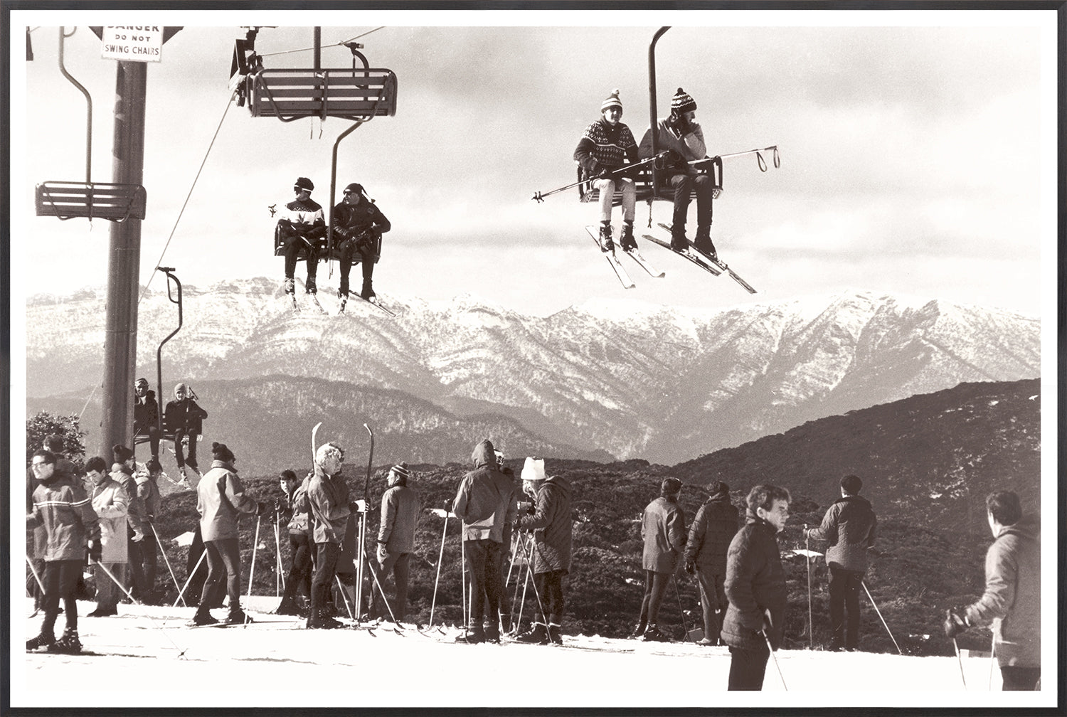 Ski Summit C. 1966 wall art featuring skiers on a chairlift with snowy mountains in the background.