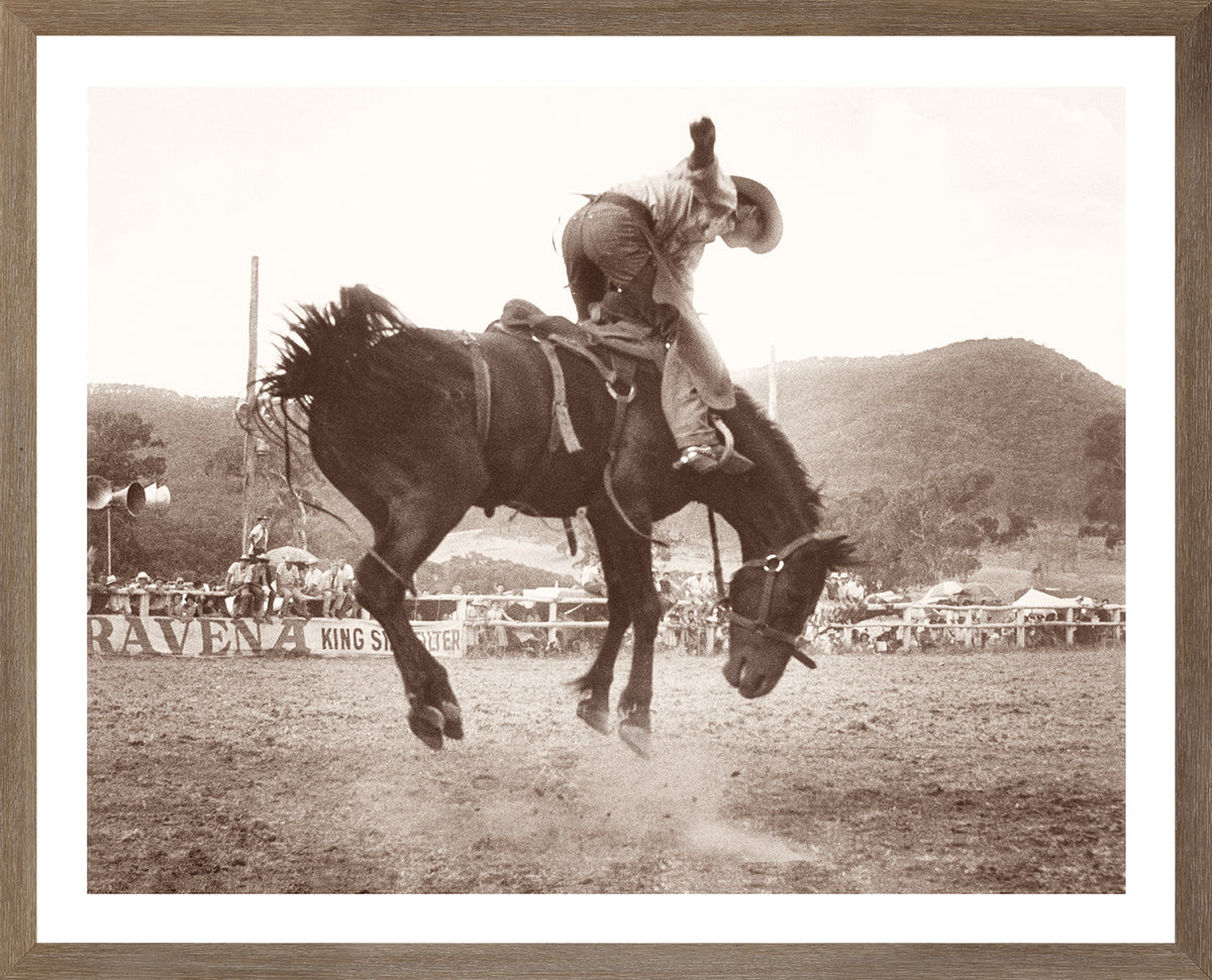 Rodeo I C. 1962 wall art featuring a cowboy riding a bucking horse in sepia tones.