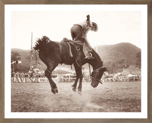 Rodeo I C. 1962 wall art featuring a cowboy riding a bucking horse in sepia tones.