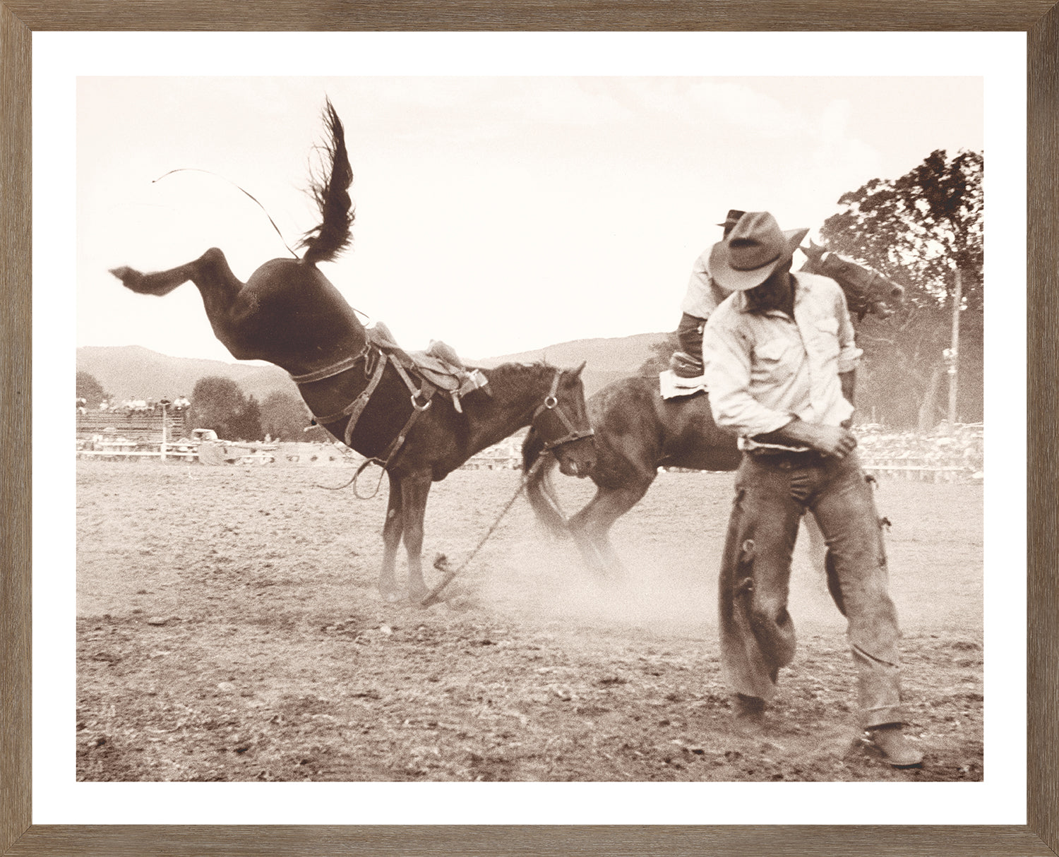 Rodeo III C. 1962 wall art featuring a cowboy riding a bucking horse in sepia tones