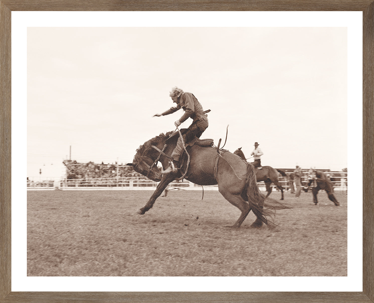 Rodeo IV C. 1962 wall art featuring a cowboy riding a bucking horse in sepia tones.