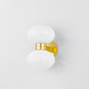 Close-up of the Otsego Wall Sconce in aged brass showing the arm curve and shade silhouette.