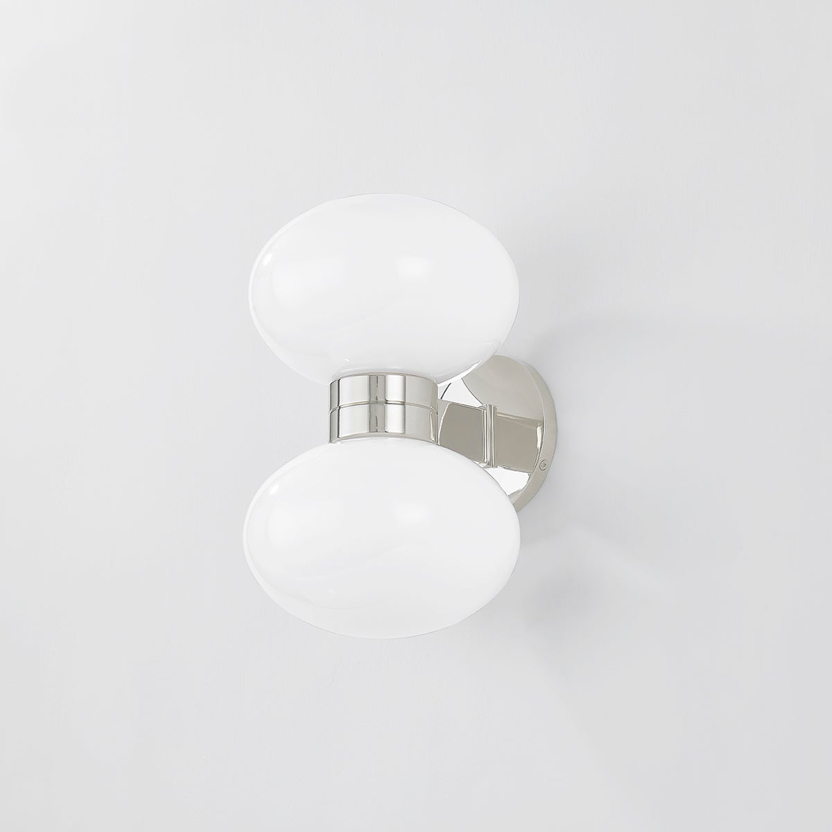 Close-up of the Otsego Wall Sconce in polished nickel showing the arm curve and shade silhouette.