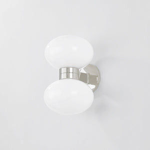 Close-up of the Otsego Wall Sconce in polished nickel showing the arm curve and shade silhouette.