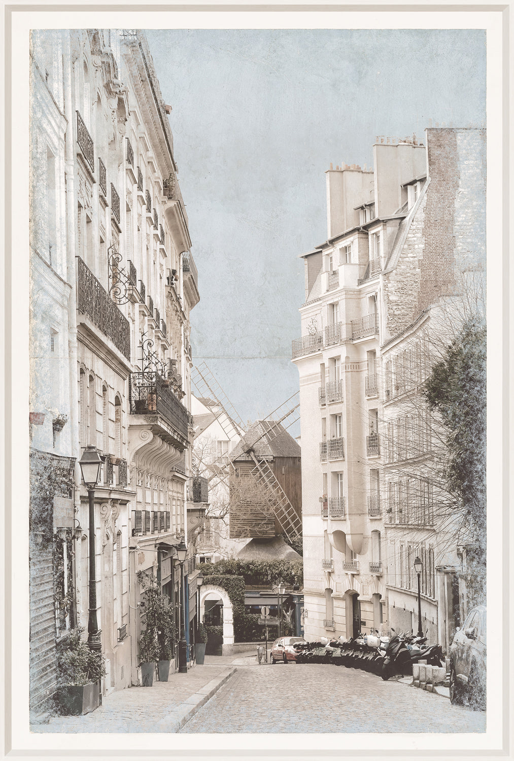 Paris Street View I wall art featuring a cobblestone street with historic buildings and a windmill.