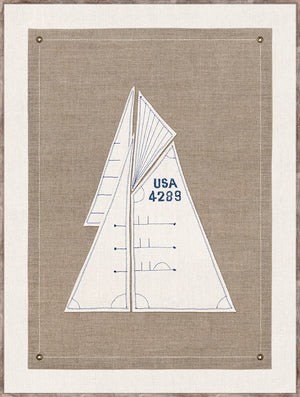 Set Sail I wall art featuring a sailboat design in blue embroidery on a beige linen background.