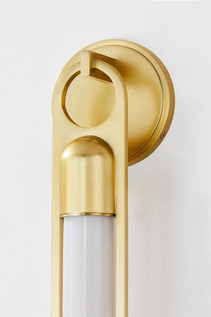 Close-up of the Bethlehem Wall Sconce in aged brass showing the arm curve and shade silhouette.