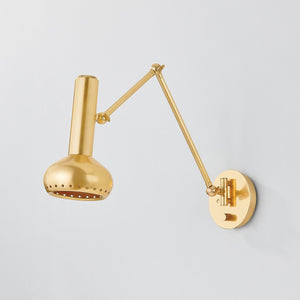 Close-up of the Roald Wall Sconce in aged brass showing the arm curve and shade silhouette.