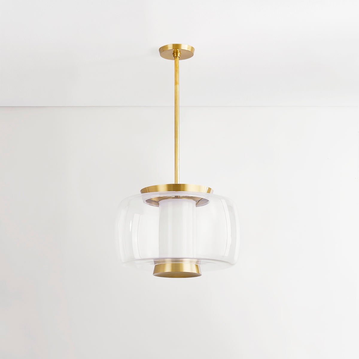 Beau Pendant 20" in aged brass shown from the front to reveal the shade shape and metal detail.