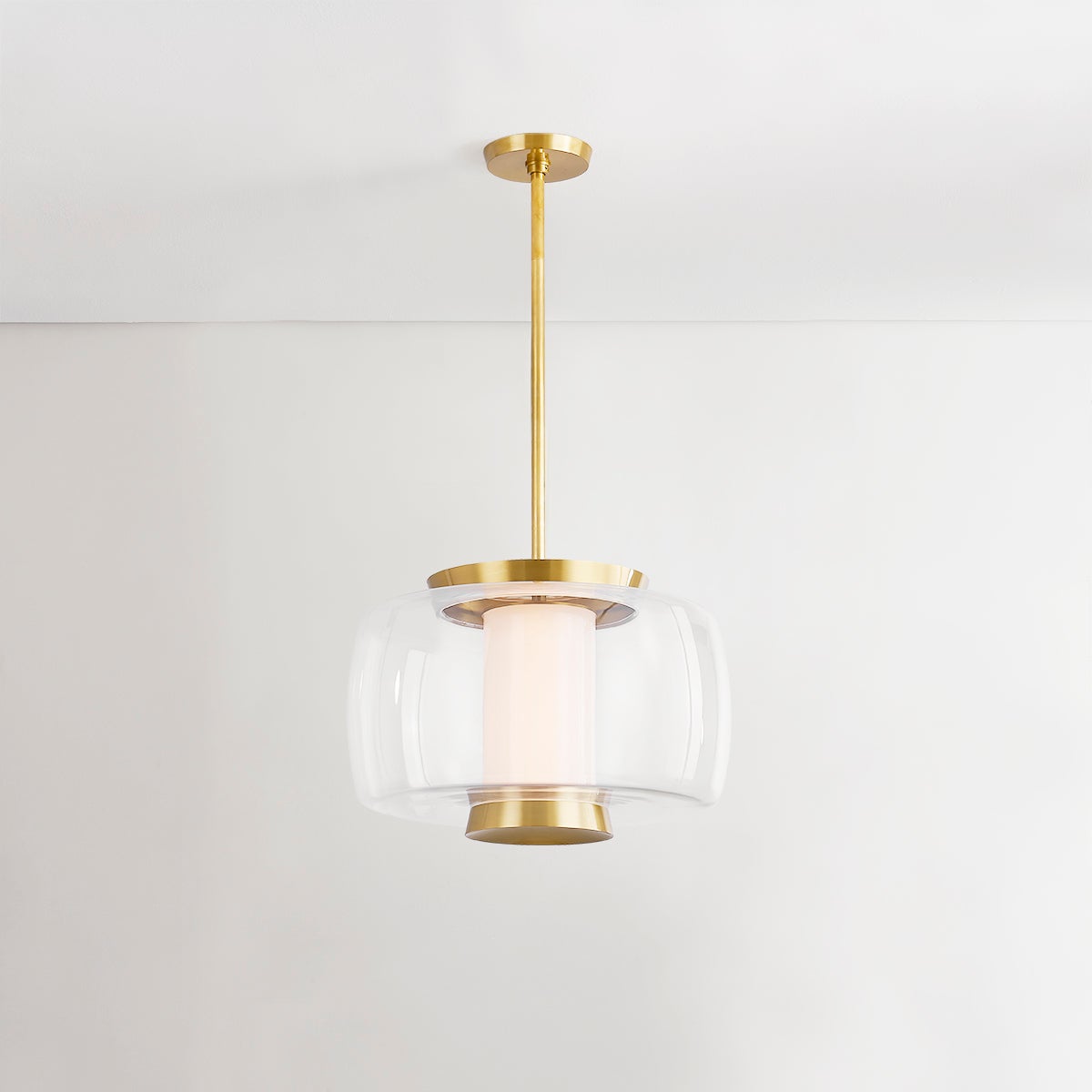 Close-up of the Beau Pendant 20" in aged brass showing the shade shape and metal detail.
