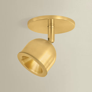 Close-up of the Tuthill Flush Mount in aged brass showing the shade profile and mounting canopy.