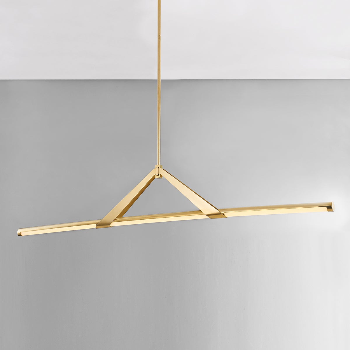 Close-up of the Jonas Linear in aged brass showing the extended frame and shade array.
