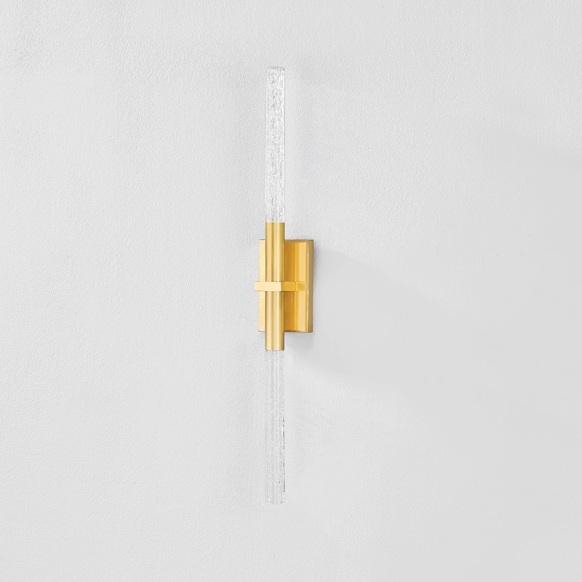 Millerton Wall Sconce in aged brass shown from the front to reveal the arm curve and shade silhouette.