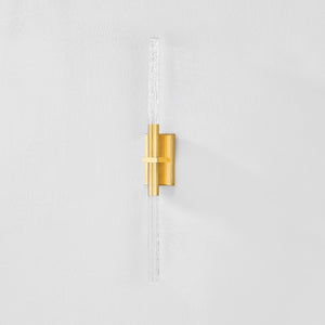 Millerton Wall Sconce in aged brass shown from the front to reveal the arm curve and shade silhouette.