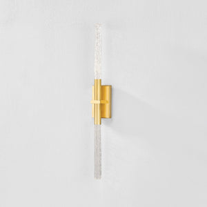 Close-up of the Millerton Wall Sconce in aged brass showing the arm curve and shade silhouette.