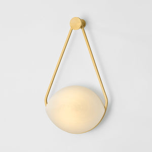 Blaina Wall Sconce in aged brass shown from the front to reveal the arm curve and shade silhouette.