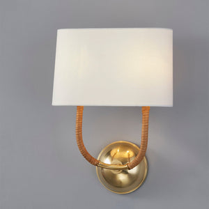 Webson Wall Sconce in aged brass shown from the front to reveal the arm curve and shade silhouette.