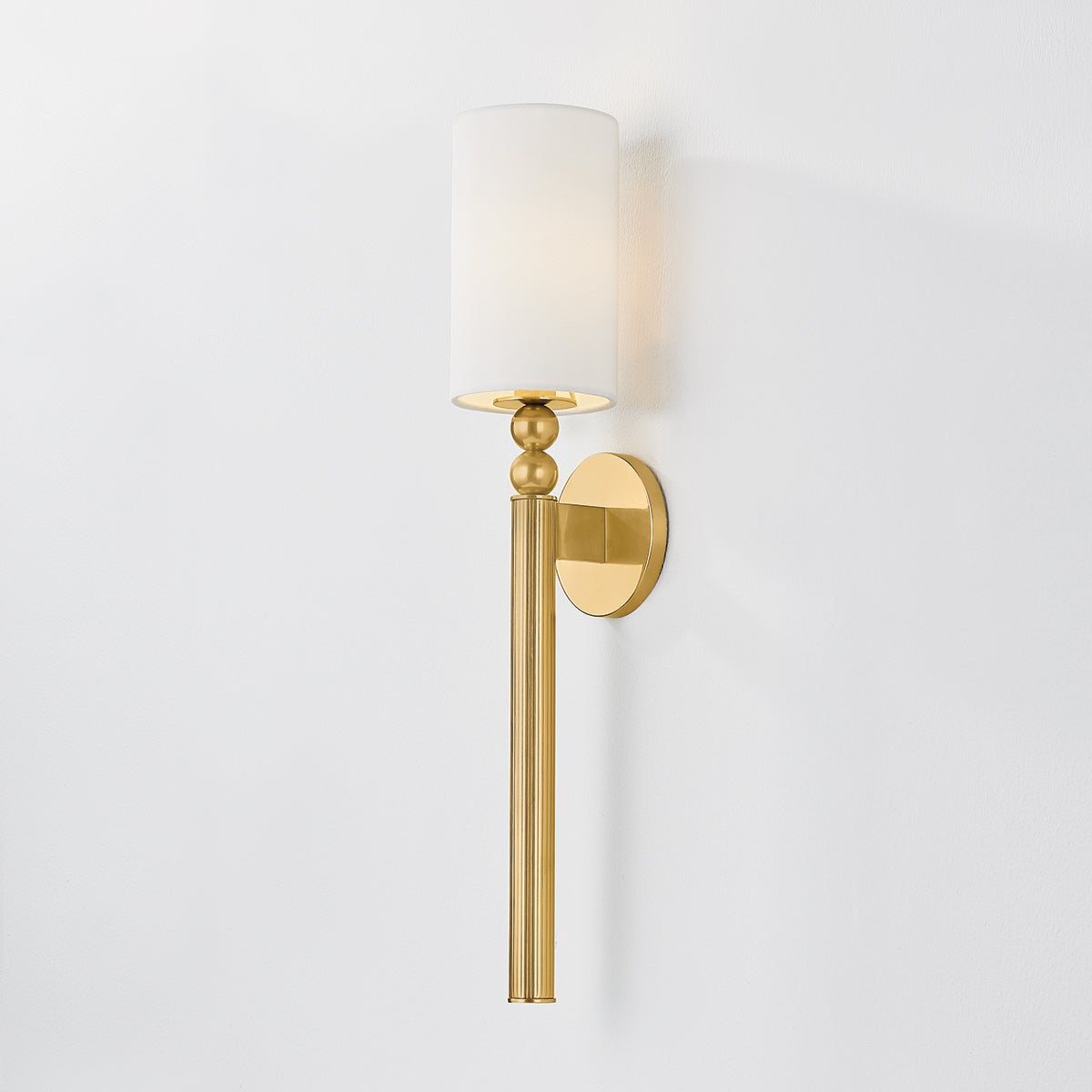 Close-up of the Lakeport Wall Sconce in aged brass showing the arm curve and shade silhouette.