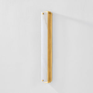 Close-up of the Edgemere Wall Sconce in aged brass showing the arm curve and shade silhouette.