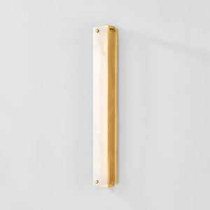 Close-up of the Edgemere Wall Sconce in aged brass showing the arm curve and shade silhouette.