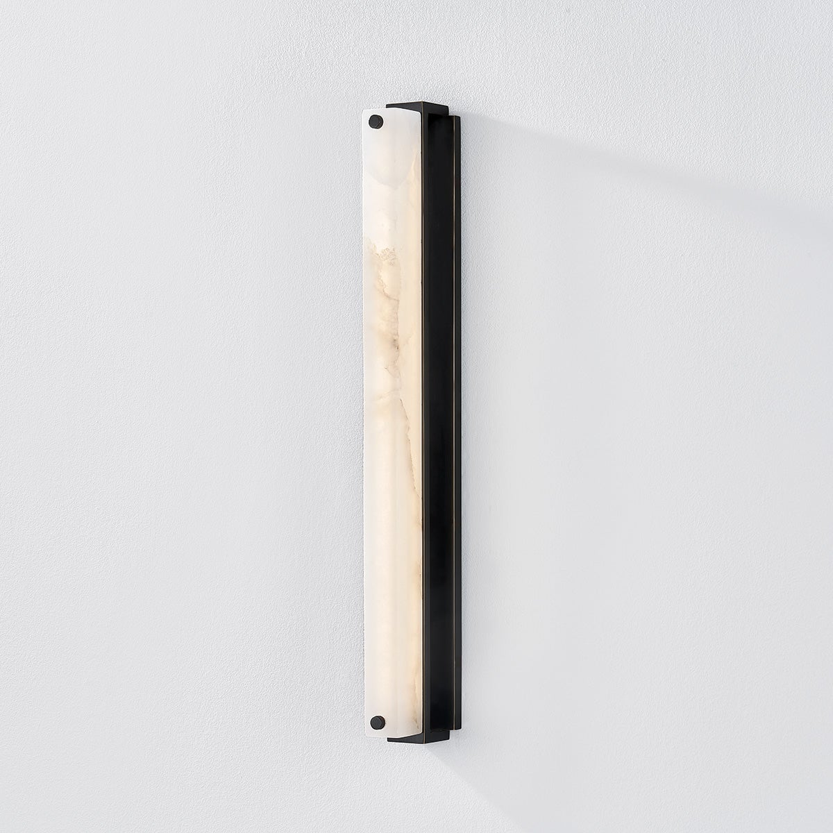 Close-up of the Edgemere Wall Sconce in dark bronze showing the arm curve and shade silhouette.