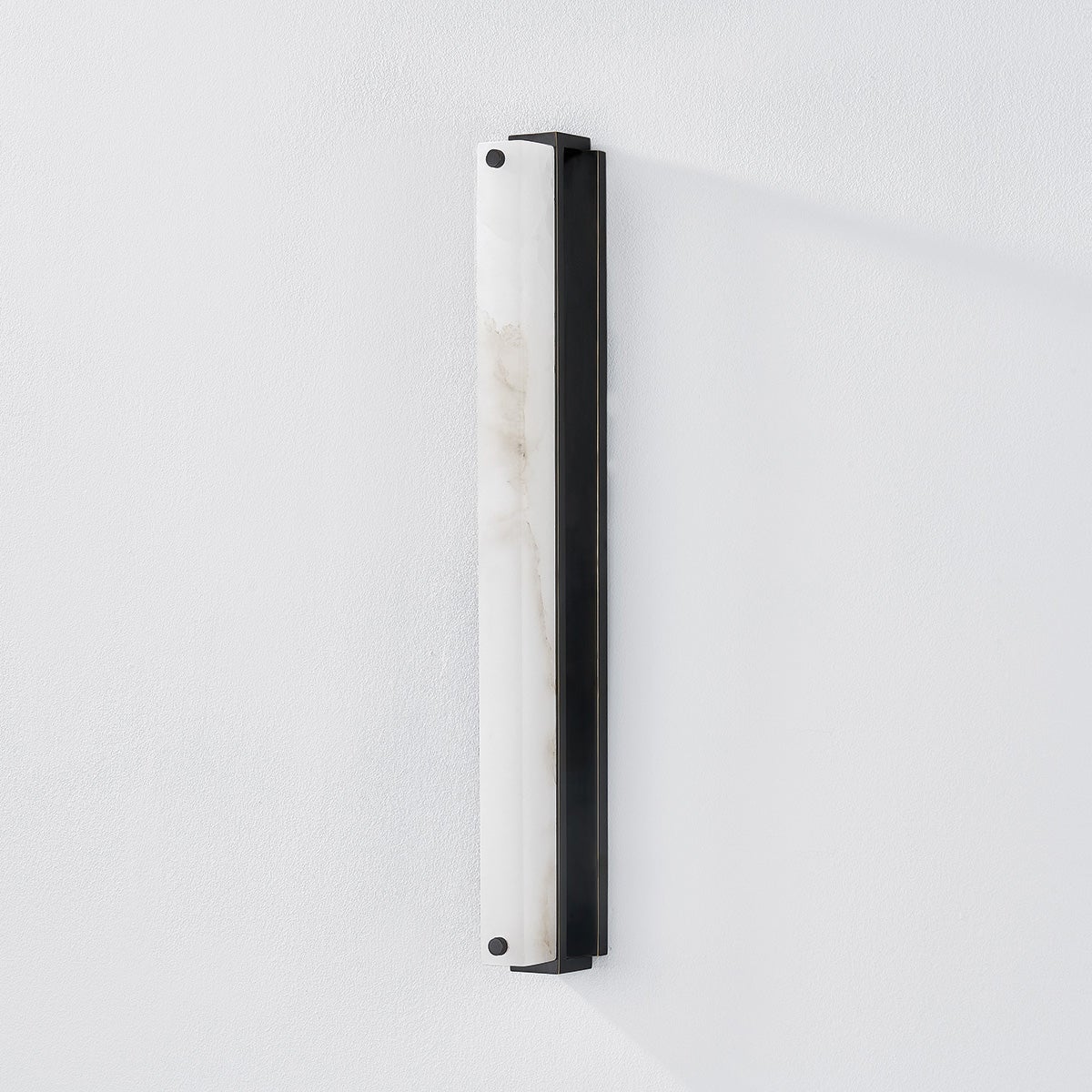 Close-up of the Edgemere Wall Sconce in dark bronze showing the arm curve and shade silhouette.