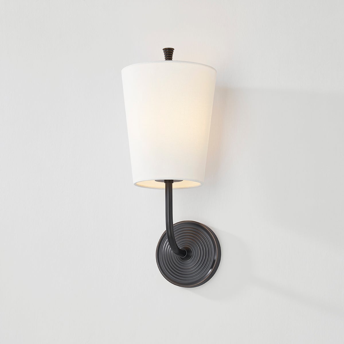 Close-up of the Gladstone Wall Sconce in dark bronze showing the arm curve and shade silhouette.