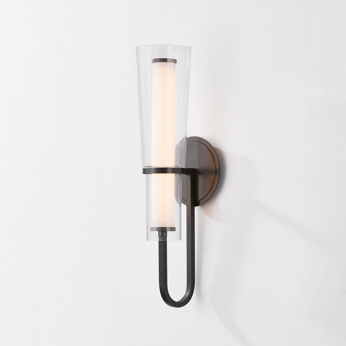 Close-up of the Vancouver Wall Sconce in bronze showing the arm curve and shade silhouette.