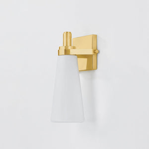 Close-up of the Trude Wall Sconce in aged brass showing the arm curve and shade silhouette.