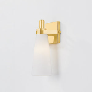 Close-up of the Trude Wall Sconce in aged brass showing the arm curve and shade silhouette.