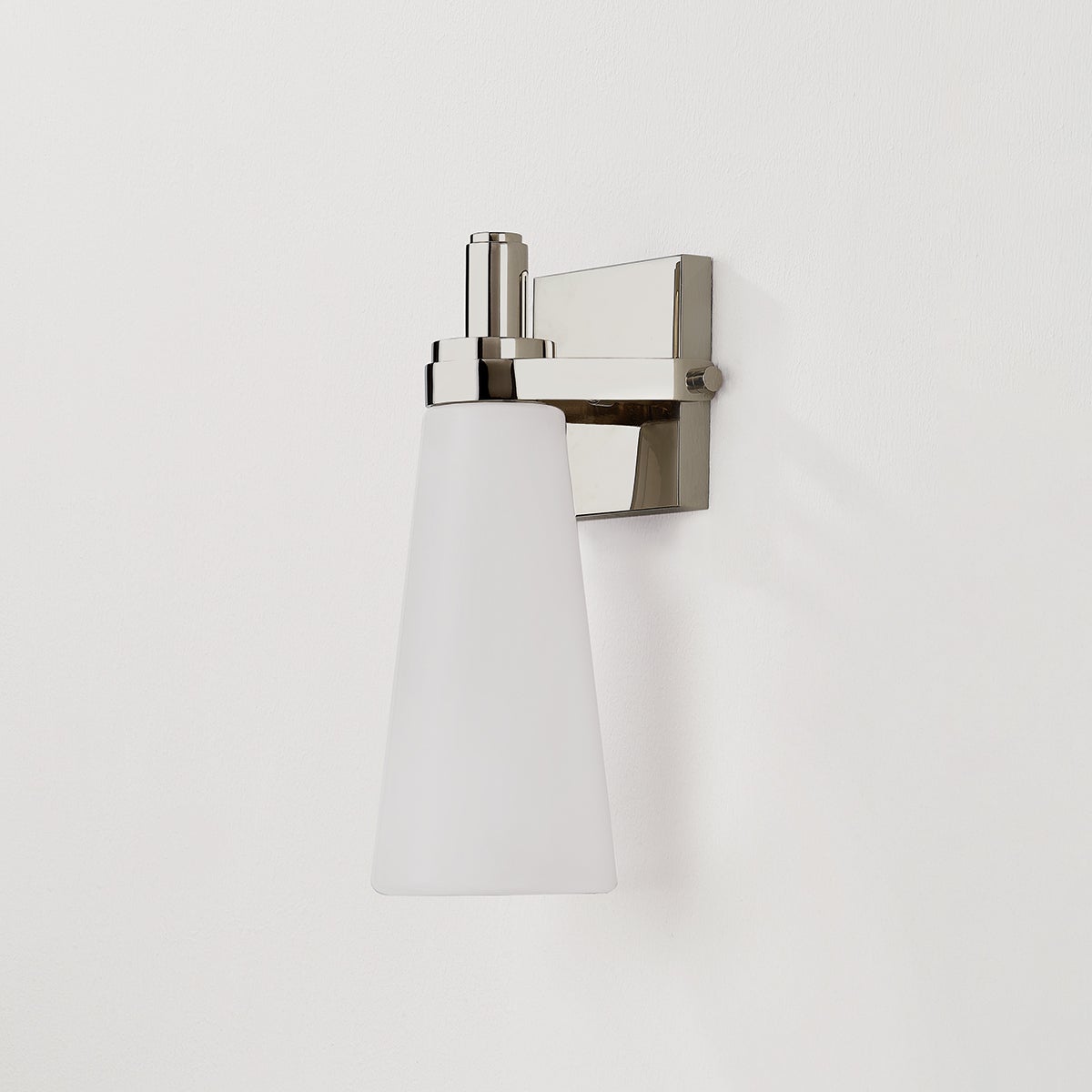 Close-up of the Trude Wall Sconce in polished nickel showing the arm curve and shade silhouette.