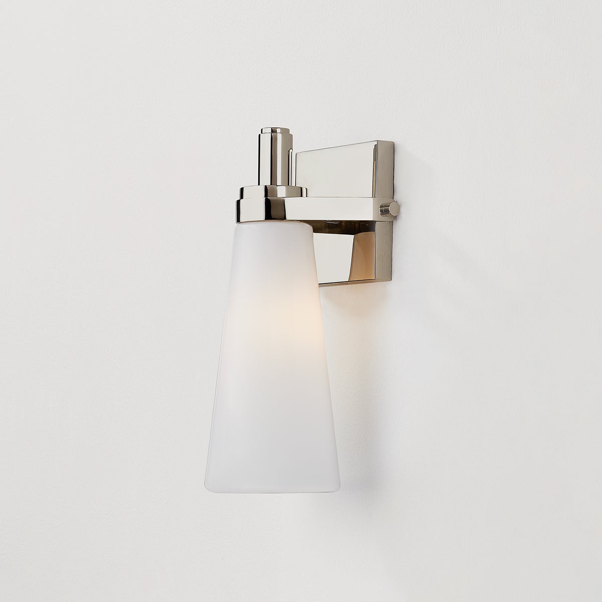 Close-up of the Trude Wall Sconce in polished nickel showing the arm curve and shade silhouette.