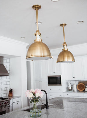 Close-up of the Massena Pendant 19.5" in aged brass showing the shade shape and metal detail.