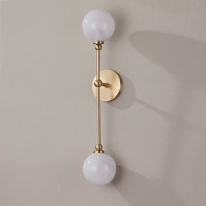 Andrews Wall Sconce in aged brass shown from the front to reveal the arm curve and shade silhouette.