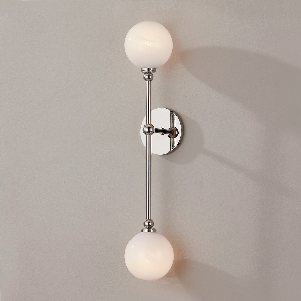 Close-up of the Andrews Wall Sconce in polished nickel showing the arm curve and shade silhouette.
