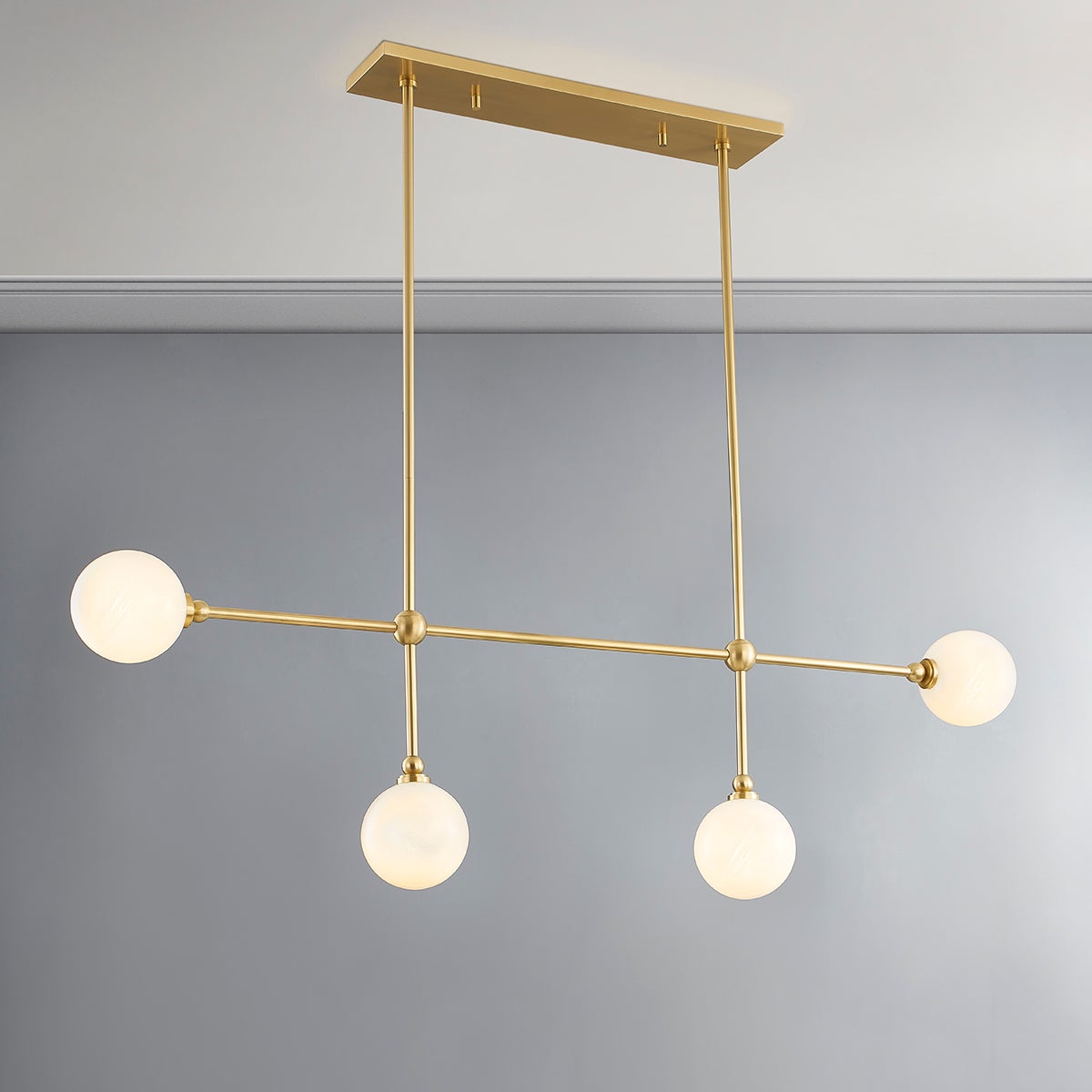 Andrews Linear in aged brass shown from the front to reveal the extended frame and shade array.