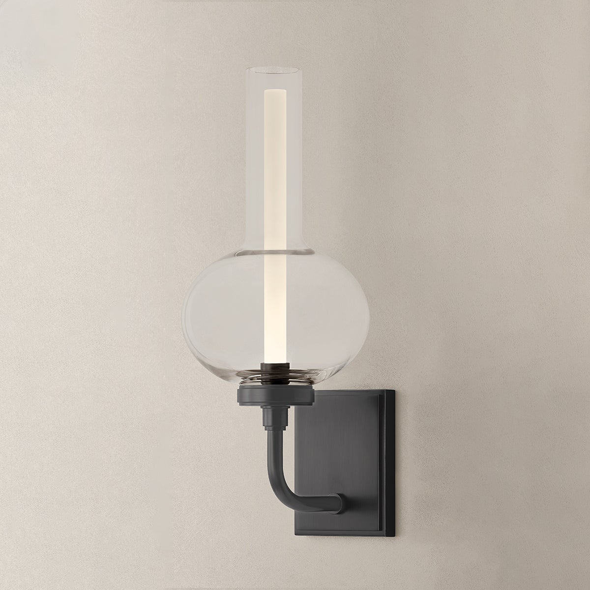 Close-up of the Rossman Wall Sconce in dark bronze showing the arm curve and shade silhouette.