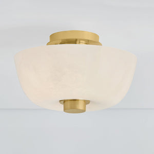 Dove Flush Mount in aged brass shown from a second angle to highlight the shade profile and mounting canopy.