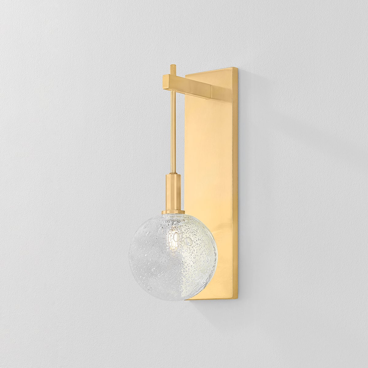 Close-up of the Onteora Wall Sconce in aged brass showing the arm curve and shade silhouette.
