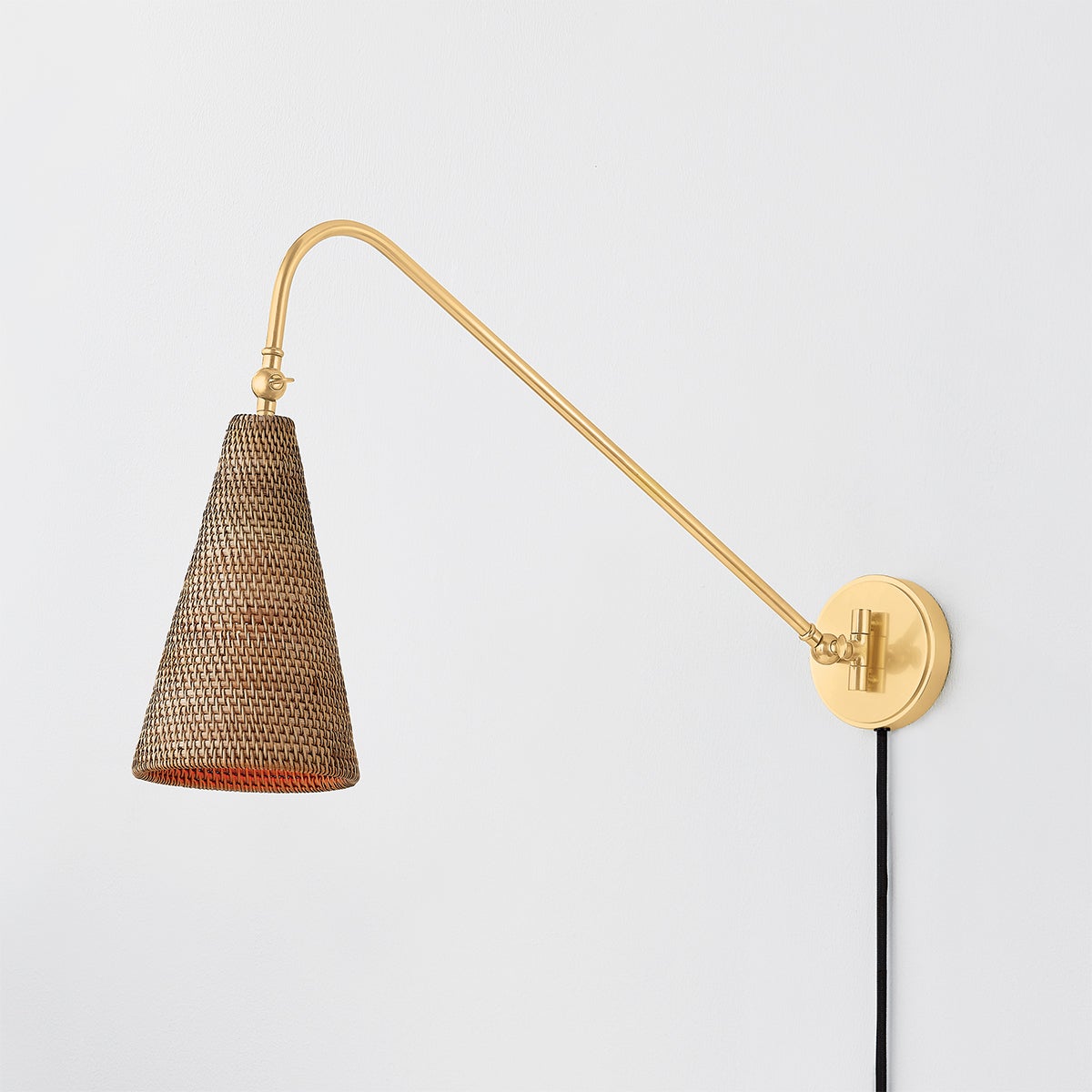 Close-up of the Averack Plug-In Sconce in aged brass showing the arm profile and shade silhouette.
