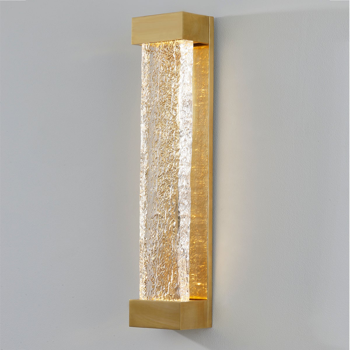 Close-up of the Wharton Wall Sconce 5" x 23" in aged brass showing the arm curve and shade silhouette.
