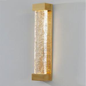 Close-up of the Wharton Wall Sconce 5" x 23" in aged brass showing the arm curve and shade silhouette.