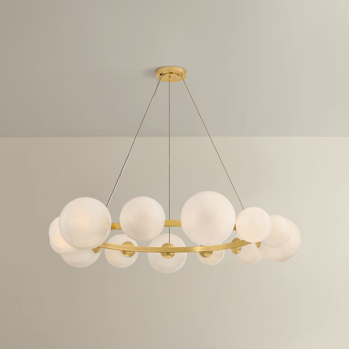 Close-up of the Pacama Chandelier 55" in aged brass showing the frame, arms, and shade detail.