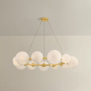 Close-up of the Pacama Chandelier 55" in aged brass showing the frame, arms, and shade detail.