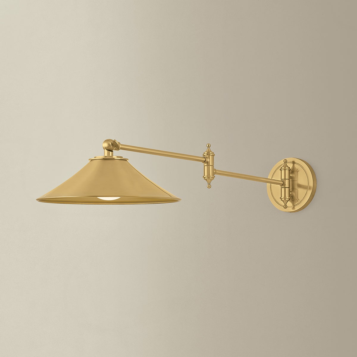 Lithgow Wall Sconce in aged brass shown from the front to reveal the arm curve and shade silhouette.