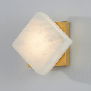 Brockton Wall Sconce in aged brass shown from the front to reveal the arm curve and shade silhouette.