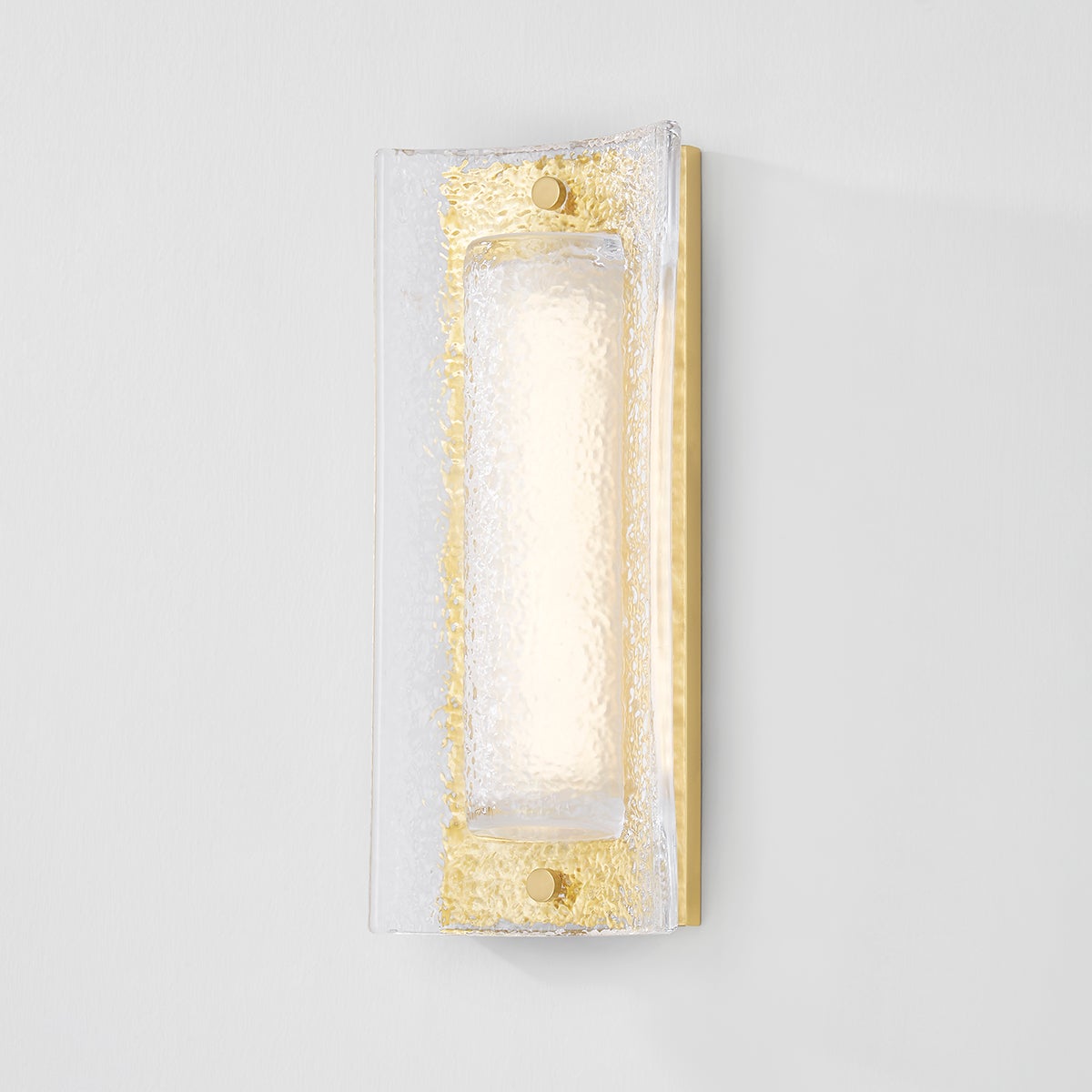 Close-up of the Philmont Wall Sconce in aged brass showing the arm curve and shade silhouette.
