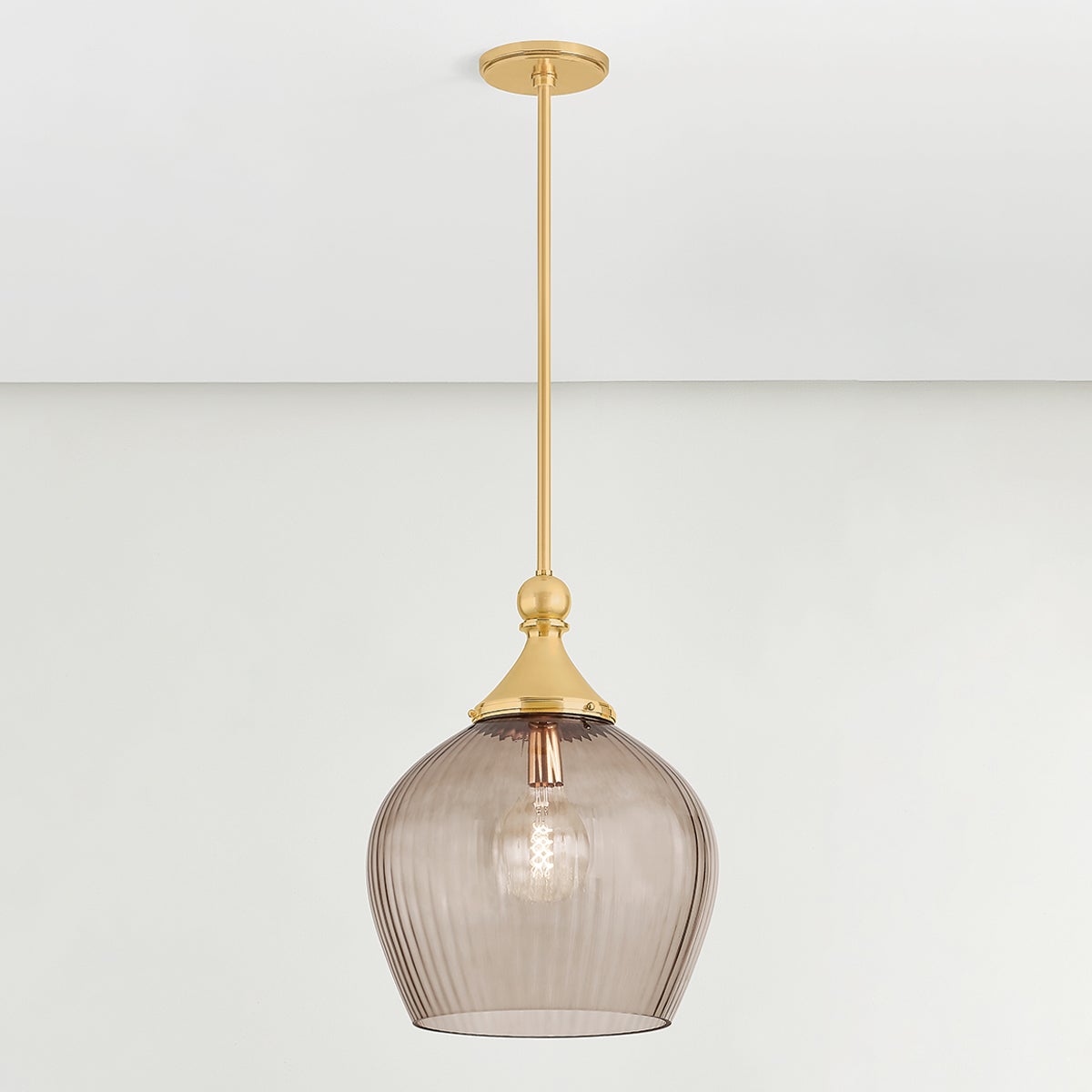 Close-up of the Chatton Pendant 16.5" in aged brass showing the shade shape and metal detail.