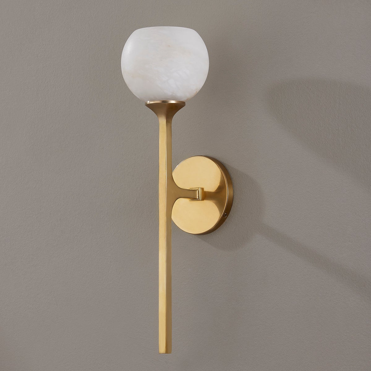 Melton Wall Sconce 1-Light 5" x 18.5" in aged brass shown from the front to reveal the arm curve and shade silhouette.