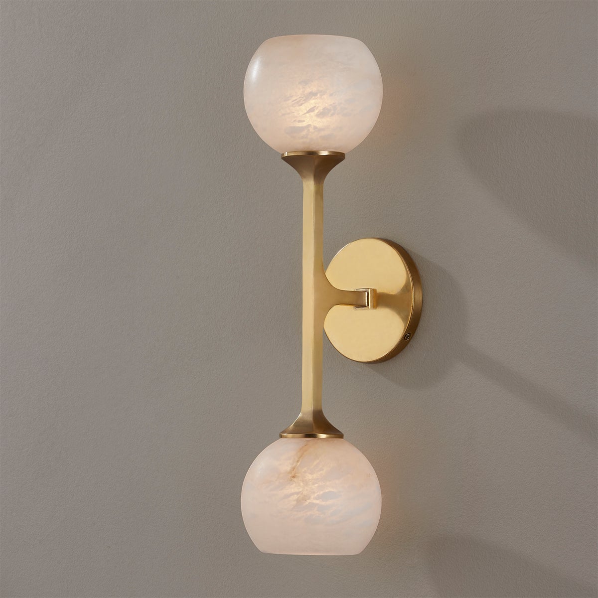 Close-up of the Melton Wall Sconce 2-Light 5" x 18.5" in aged brass showing the arm curve and shade silhouette.